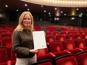 Marianne met de braillefolder in haar hand
